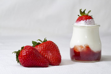 Two strawberries and yogurt