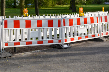 Construction site with barriers and lights in a park