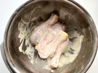 raw chicken legs. marinated chicken legs in white sauce. Top view.