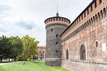 Fragment of the fortress wall and a corner tower of the Sforzesco Castle - Castello Sforzesco in Milan, Italy