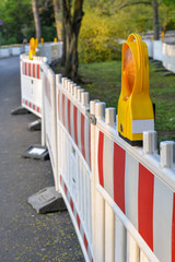 Construction site with barriers and lights in a park close up