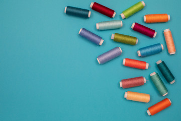 Multicolored cotton threads, spools, handmade sewing. Top view with copyspace, flat lay.