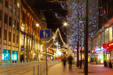 Fototapeta na wymiar Festive Christmas atmosphere with bright illumination on the central Helsinki street in Finland on Christmas night.