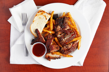 Mouth watering barbecue ribs with fries