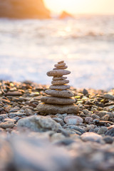 Stack of stones on the beach of Karavostamo while sunset