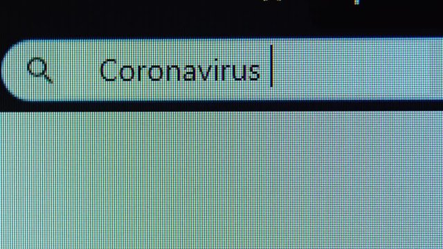 Browser bar with Coronavirus symptoms text typed on the computer monitor. Shot in 4k resolution