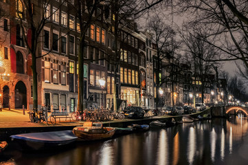Fototapeta na wymiar Canals of Amsterdam in night illumination