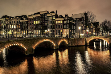 Fototapeta na wymiar Canals of Amsterdam in night illumination