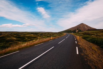 number one road in Iceland leading to the mountain through moss-covered lava fields