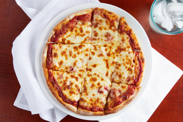 A golden cheesy pepperoni pizza with square slices