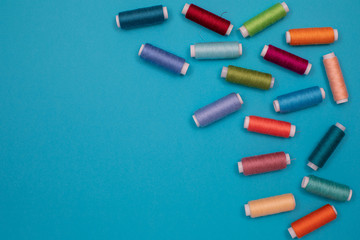 Multicolored cotton threads, spools, handmade sewing. Top view with copyspace, flat lay.