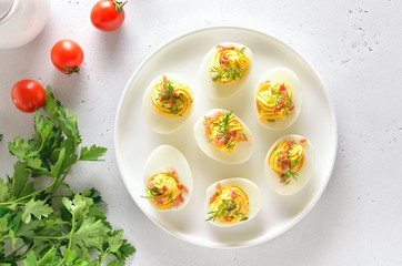 Stuffed eggs with egg yolk, bacon, mustard and dill