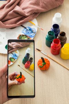The child is playing with stones from children’s activities.kid painting 
pumpkin for her handcraft picture for nursery or kindergarten activity concept time.