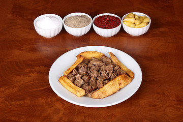 very nice roasted meat with potatoes, turkish spicy on white plate