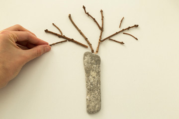 The child is playing with stones from children’s activities.kid making step by step tree for her...