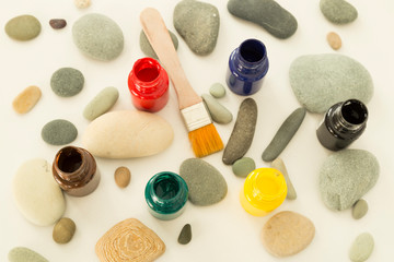 The child is playing with stones from children’s activities.kid draws something for her handcraft picture for nursery or kindergarten activity concept time.