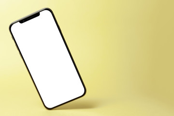 Smart phone mock up, phone with blank screen and shadow isolated on yellow background. Modern technologies social networks and applications. Symbol of lightness freshness airiness. Copy space