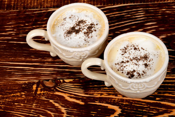 two cups with coffee and milk froth with empty space for text