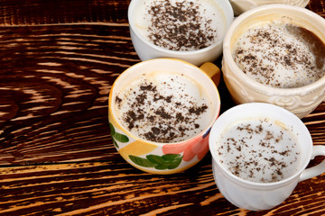 many different cups with coffee and milk froth with empty space for text