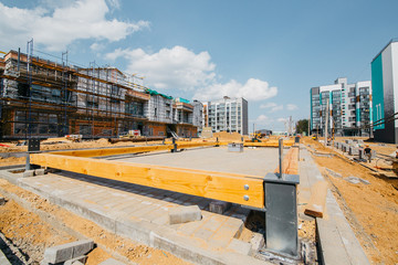 
construction site of residential buildings with cranes in sunny weather with blue sky