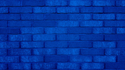 Old brick wall texture of stone blocks closeup for navy blue background.