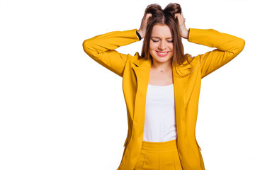 young woman in a yellow trouser suit hold hands in her hair and