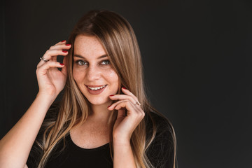 happy face of beautiful woman in dark clothes on dark background