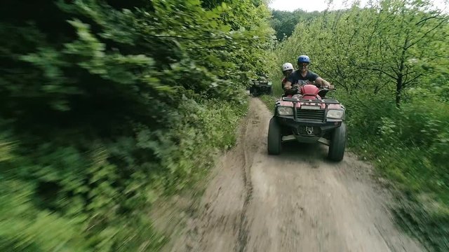 Cheerful company on vacation ..video of young people riding ATVs . Four-wheel ATV transport and extreme sport.little fun.ATVs.Quad Bikes.