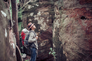 Male hiker Shoulder bag backpack walking lost in the rocky valley. Travel who like to challenge and relax. The concept of camping and hiking. Add film grain filter.