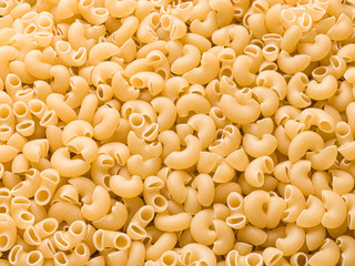 Uncooked macaroni elbow shape pasta with white background stock image. 