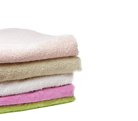 Obraz na płótnie Canvas clean and soft towels stacked colorful towels isolate on white background