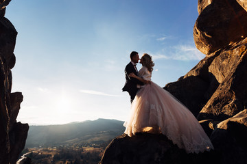 bride in stylish dress with lace and groom in suit. newlyweds hu