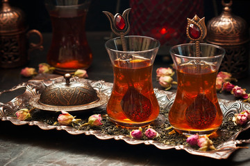 Traditional Turkish  tea in traditional  glass cups on  dark table