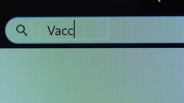 Browser tab with vaccine word typed on the computer monitor. Shot in 4k resolution