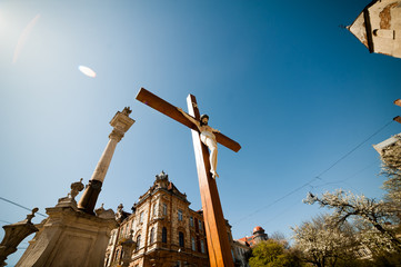 Big wooden christian cross near church
