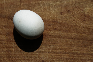 Egg on wooden board