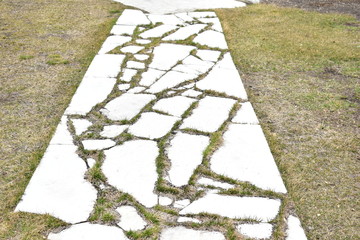 Paved with marble slabs path to the courtyard