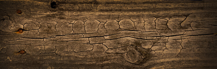 Dark stained wood board with grain knots and texture