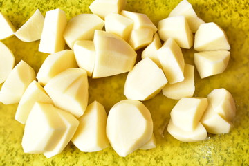 Sliced fresh potatoes and cutting them with a knife