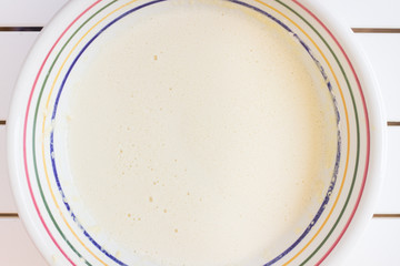 Bowl with beaten eggs milk flour for cooking pancakes - 340400151