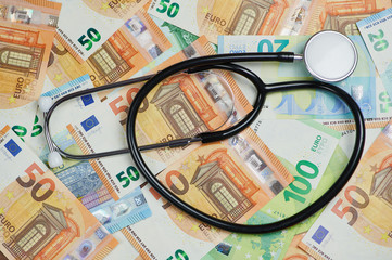 stethoscope is lying on a lot of Euro banknotes