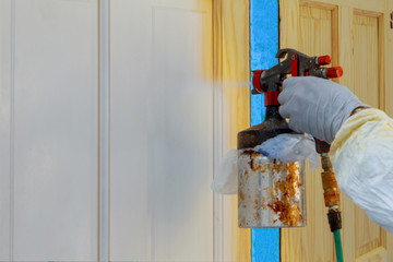 Painting the door with a spray gun