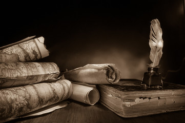 Quill pen, inkwell and old rolled up maps and papers, sepia effect - 340403167