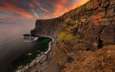 Fototapeta na wymiar Ireland countryside tourist attraction in County Clare. The Cliffs of Moher and castle Ireland. Epic Irish Landscape UNESCO Global Geopark the wild atlantic way. Beautiful scenic nature hdr Ireland.