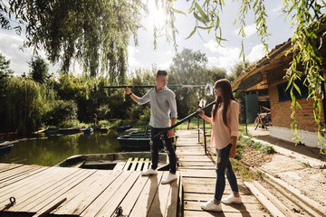 Cute couple walking near water. Girl in a white shirt. Pair by the river. Loving young couple near the river with boats. love without borders. selective focus