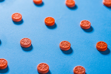 Pills like an orange on a blue background. Vitamin C. Health concept