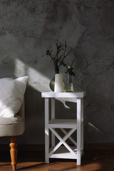cushions and a knitted plaid on the sofa. A cozy sunlight light from window.