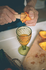 The man making orange juice at home. Preparation of orange juice. Health concept. Soft focus