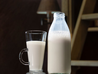 Glass and open bottle with pasteurized cow's milk
