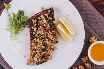 fried dish made of breaded river fish fillet Carp served on a plate at a restaurant